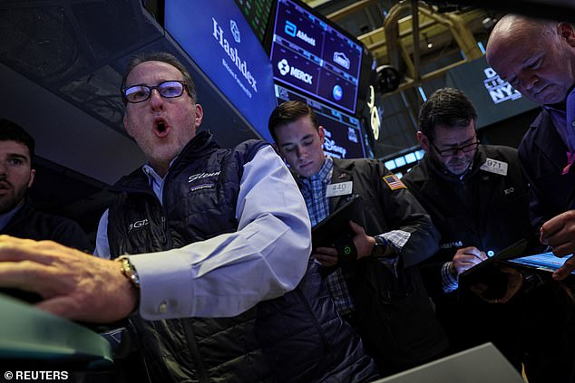 Traders work on the floor of the New York Stock Exchange on Wednesday. Wall Street's main stock indexes dropped on Wednesday, as worries related to Credit Suisse battered sentiment